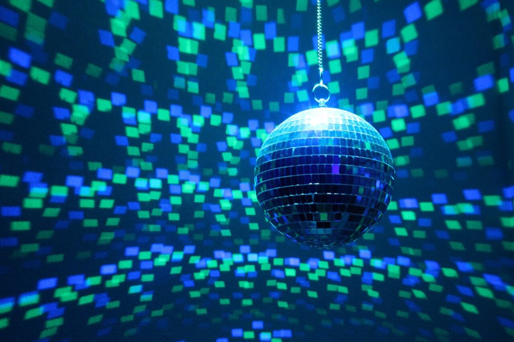 a mirror ball throwing squares of light across a dark room